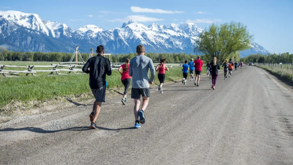 Teton 1 Runners on path with snowy teton mountains in the background