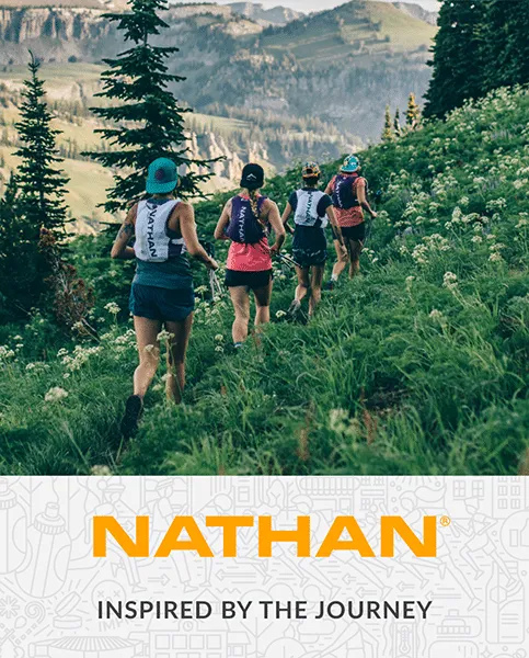 An ad for NATHAN depicting runners hiking on a grassy slope with mountains in the distance