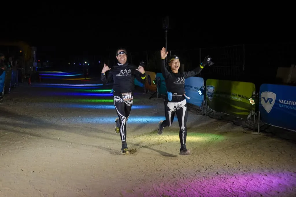 Joshua Tree__D4R9968 a couple wearing skeleton pants running across the finish line