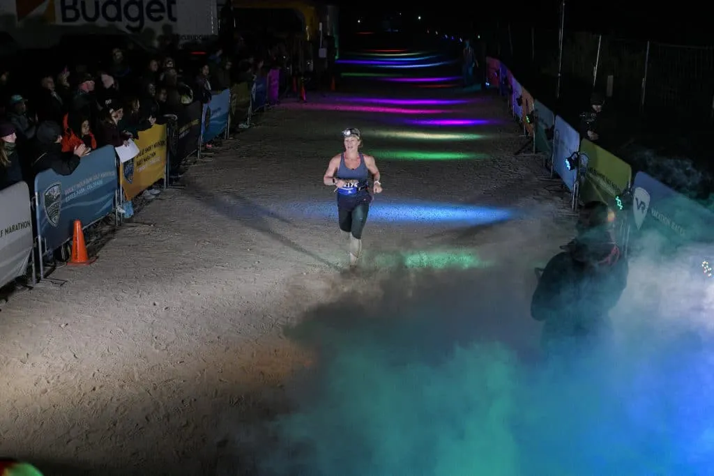 Joshua Tree__RLI4844 a woman approaching the finish line through a fog machine