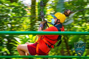 A person in red zipping through the trees