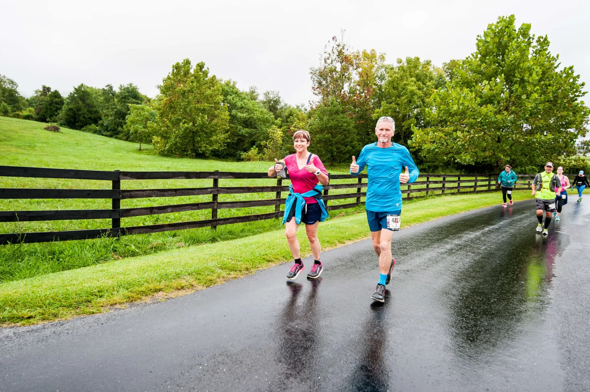 Shenandoah 2017_LUC8968 Two Vacation Races runners smiling as they jog down a wide paved road at Shenandoah Half Marathon